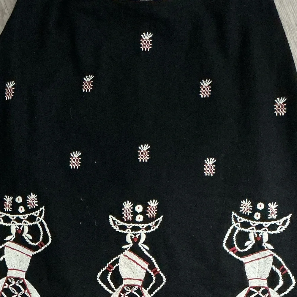 A-line midi skirt with white and red embroidered figures and a ruffled red hem🌻